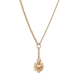 Gold necklace with a heart-shaped pendant on a white background