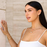 Woman in a white camisole wearing fabulous diamond jewelry